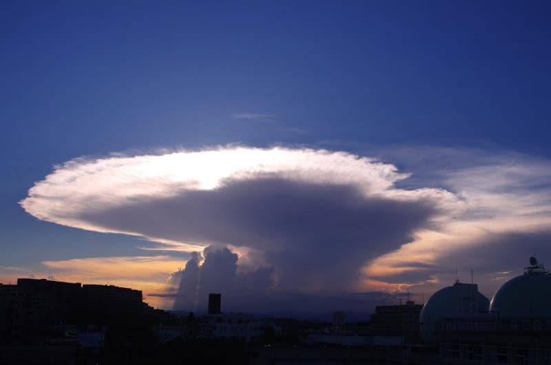 Cumulonimbus incus thunderstorm with a wide flat anvil top spreading sideways