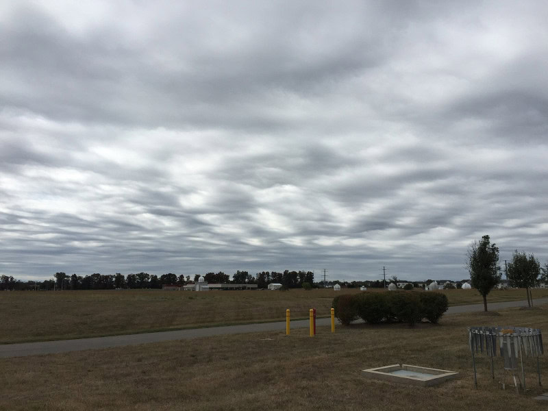 Asperitas clouds forming a dark, rippled wave pattern resembling a rough sea viewed from below