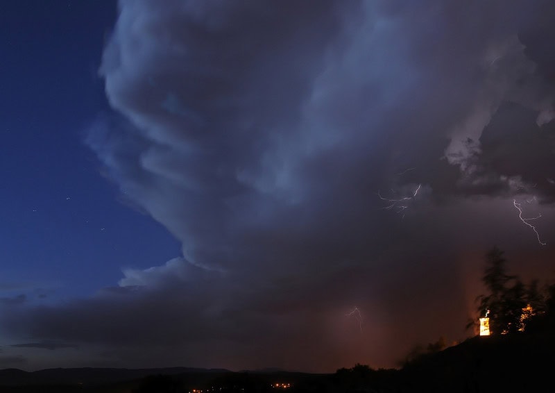 Towering cumulonimbus thunderstorm cloud with lightning
