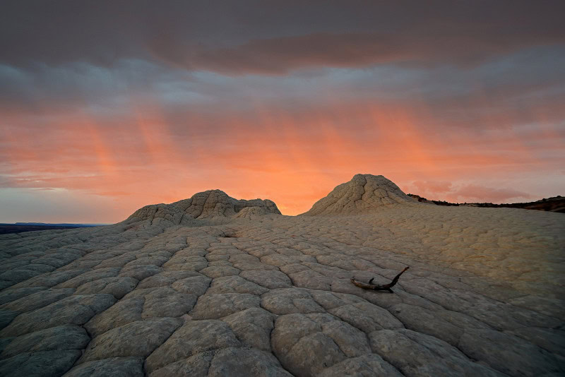 Virga showing wispy streaks of precipitation trailing from a cloud base and evaporating before reaching the ground over desert