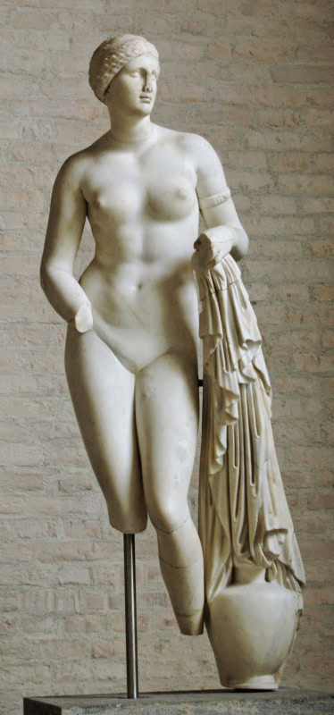 Marble nude Aphrodite reaching towards a water jar draped with cloth beside her right leg