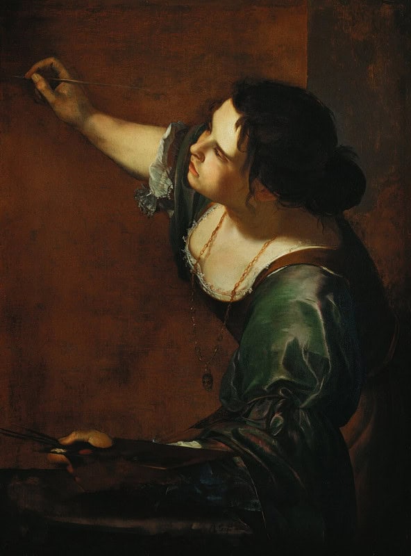 Woman in a green dress with rolled sleeves leaning forward over a canvas, her right arm raised holding a brush and her left hand holding a palette, a gold chain with a mask pendant at her neck, hair loose and disordered