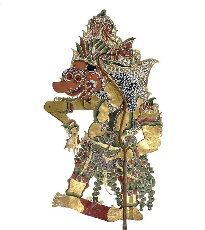 Ornate Javanese wayang kulit shadow puppet of Batara Kala with tusks, an open mouth and elaborate painted detail