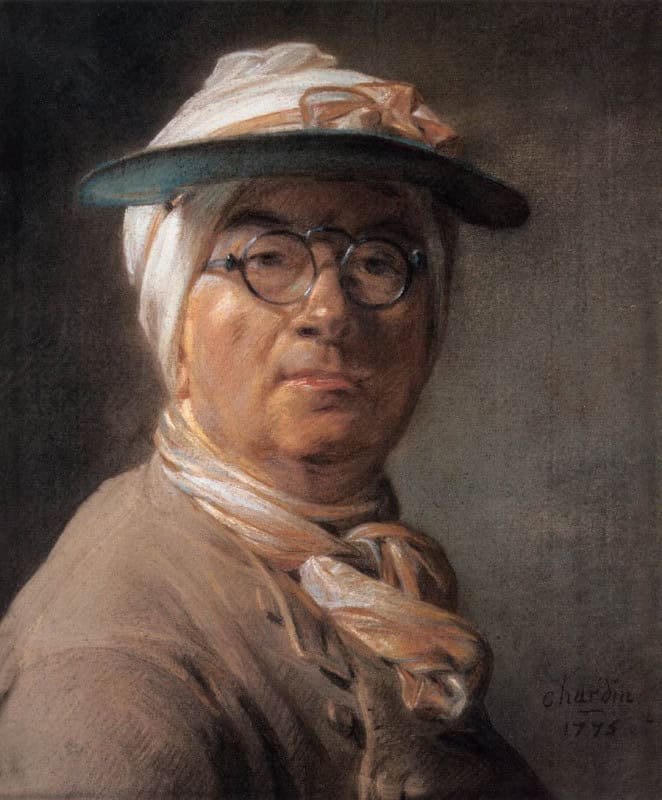 Elderly man in a blue-green eyeshade tied over a white headscarf, wearing round spectacles low on his nose and a pinkish neckerchief, looking out with raised eyebrows