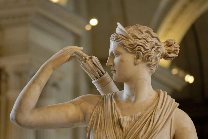 Detail of the marble Artemis reaching over her shoulder to draw an arrow from her quiver