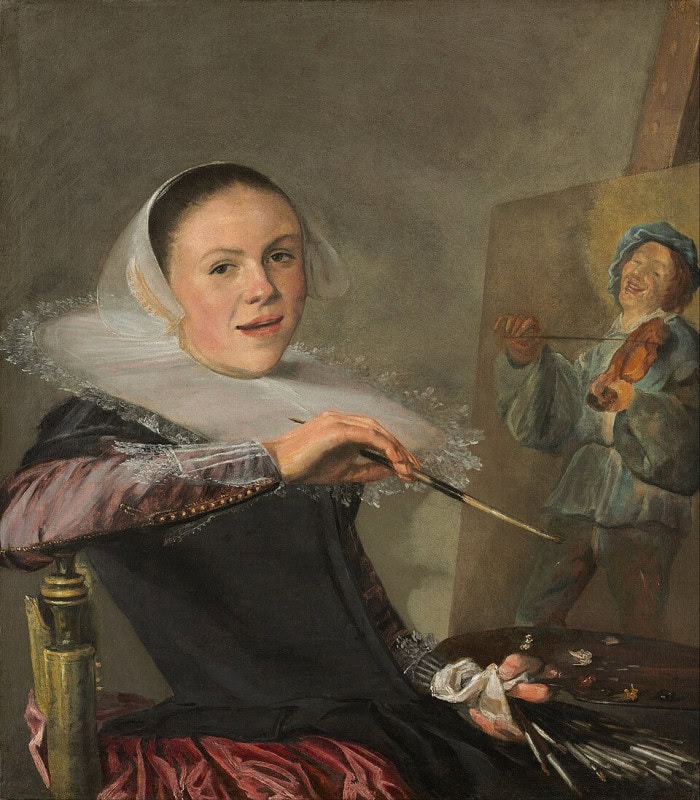 Woman in a broad flat lace-trimmed white collar and dark dress, seated with one arm over the back of her chair, brush and palette in hand, smiling and turning towards the viewer, an easel beside her showing a fiddler