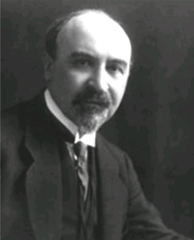 Black-and-white studio portrait of Leo Baekeland, seated, bald with a moustache and pointed beard, wearing a dark jacket, waistcoat and winged collar