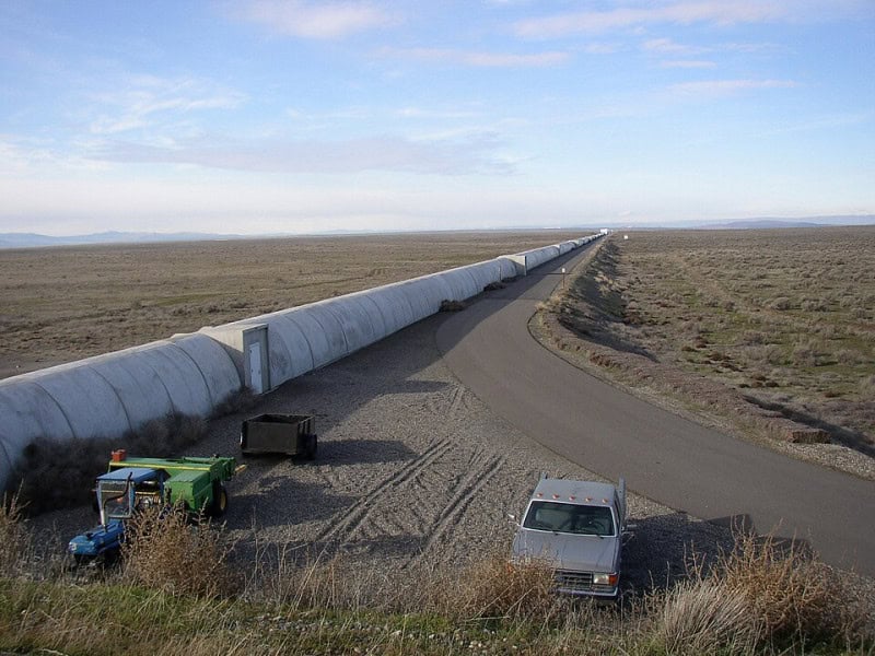 One four-kilometre concrete arm of the LIGO interferometer running to the horizon across scrubland at Hanford