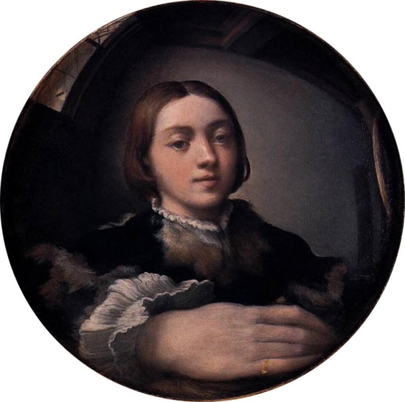 Circular painting of a young man with dark hair in a dark garment with a white ruffled cuff and collar, his hand hugely enlarged and curving across the whole foreground, the room bending away behind him as though seen in a curved mirror