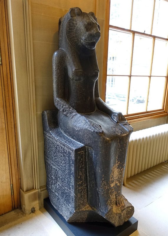 Seated dark granite statue of the lion-headed goddess Sekhmet in a corridor at Chatsworth House