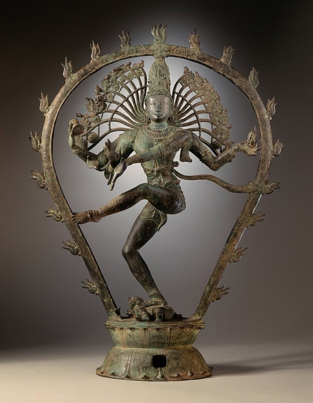 Chola bronze of Shiva as Nataraja dancing within a ring of flame, one foot raised and one pressing down a small crouching figure