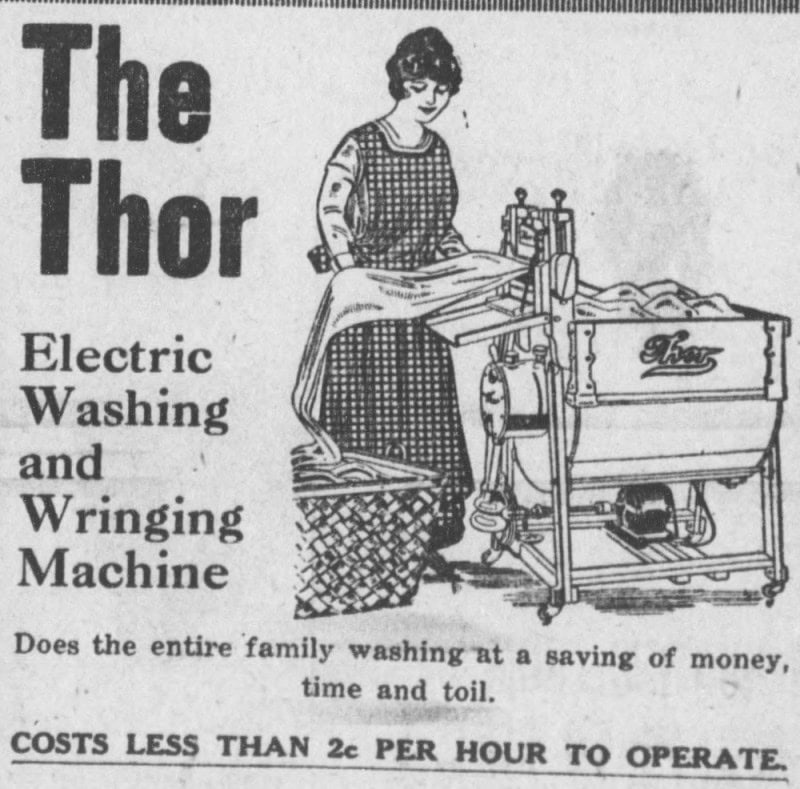 1917 newspaper advertisement headed "The Thor Electric Washing and Wringing Machine", showing a woman in a checked apron feeding sheets through the wringer of a tub washer with a belt-driven motor below