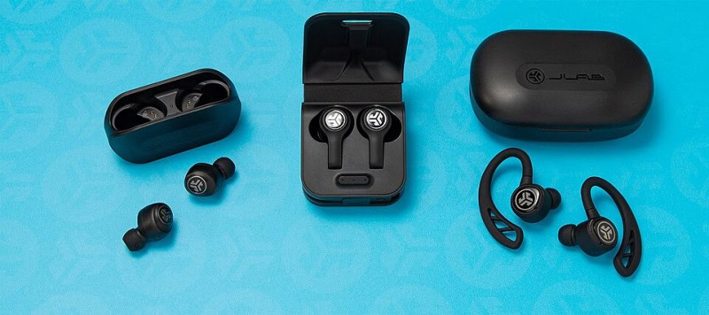 Several black true wireless earbuds and their charging cases, including an ear-hook design, arranged on a turquoise background