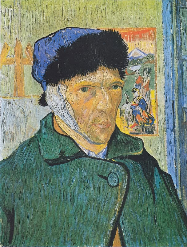 Man in a green overcoat and dark blue fur-edged cap with a white bandage covering one ear and passing under his chin, standing before a yellow-green wall, a Japanese woodblock print with an orange border pinned behind his shoulder, a canvas on an easel to one side and a blue door panel at the right edge