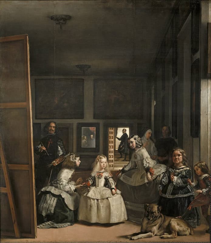 Large dim palace room with a young fair-haired princess in a pale dress at the centre surrounded by attendants and a dog, the painter himself standing at a tall canvas on the left, and a small mirror on the far wall showing two figures