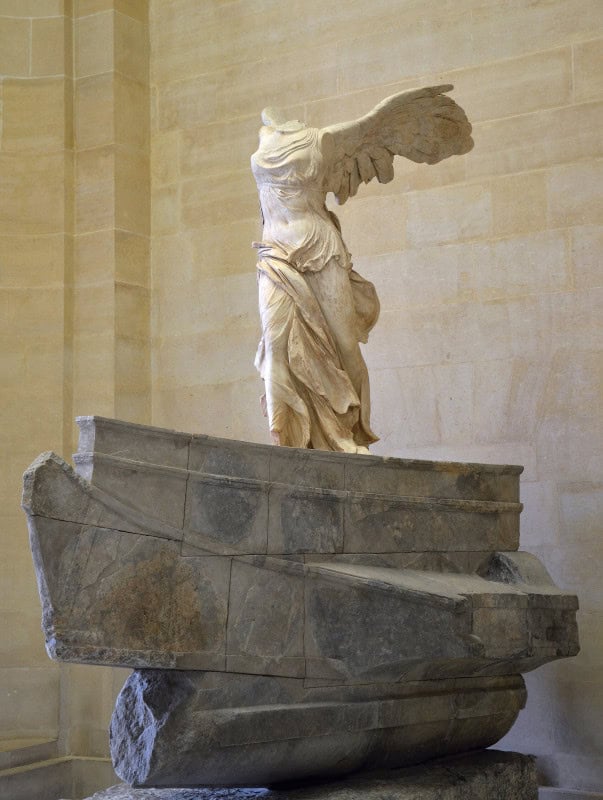 Headless winged Nike alighting on a marble ship's prow with her drapery pressed back by the wind