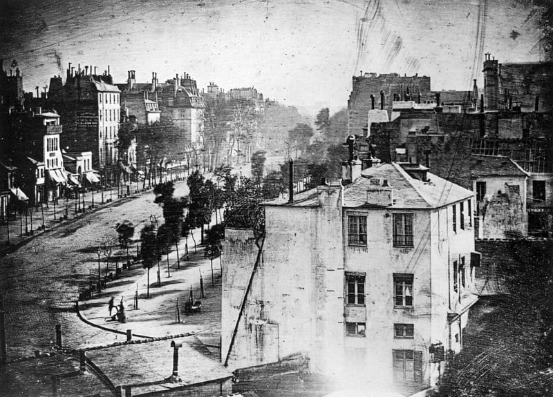 Daguerre's 1838 view of the Boulevard du Temple in Paris, an early daguerreotype of rooftops and a nearly empty street