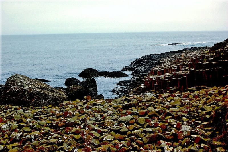 Interlocking basalt columns of the Giant's Causeway stepping down to the sea under a grey sky