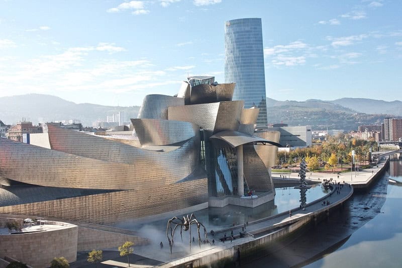 The titanium curves of the Guggenheim Museum Bilbao beside the river