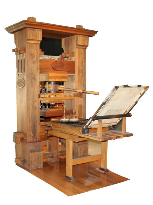 A wooden replica of a Gutenberg-style screw printing press with its bed and platen