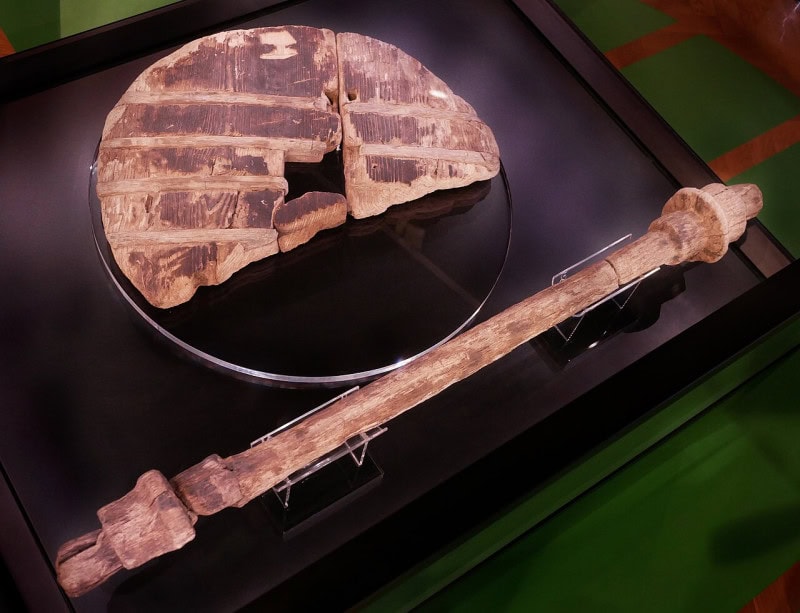 The Ljubljana Marshes wheel, a wooden disc wheel with its axle, in a museum case