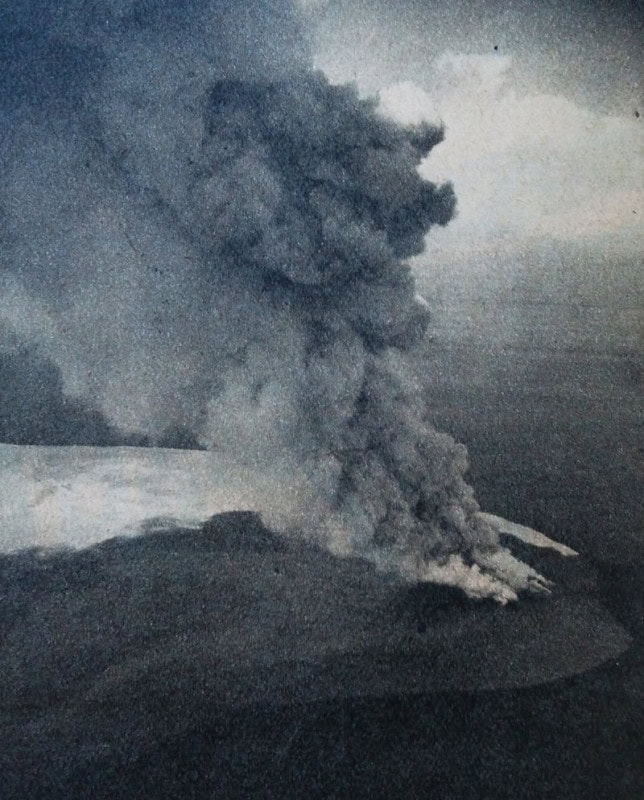 Black and white 1952 photograph of the Myojin-sho submarine eruption: a dark column of ash and steam bursting from the sea surface