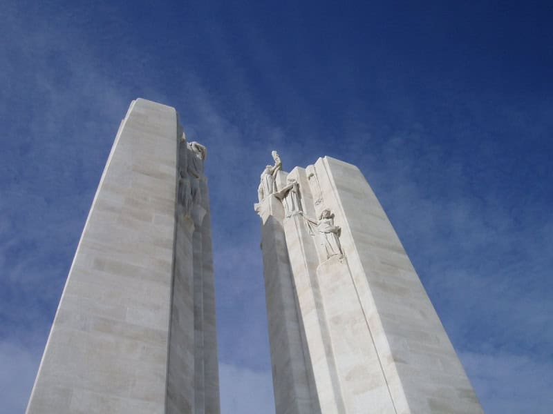 The two white limestone pylons of the Canadian National Vimy Memorial against the sky