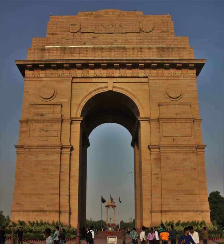 The sandstone arch of India Gate in New Delhi, photographed from the front at sunset