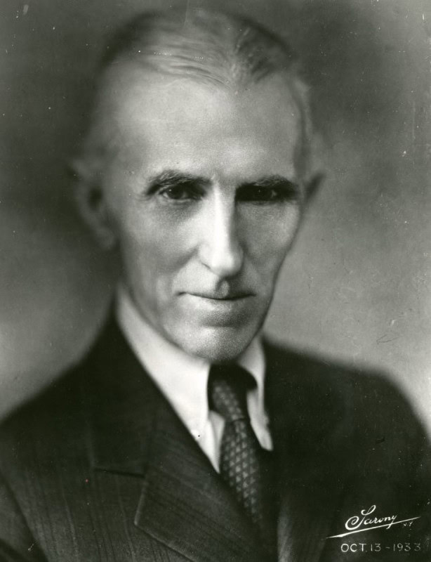 Head-and-shoulders studio portrait of Nikola Tesla in a dark suit and tie, New York, October 1933, nine months before he announced teleforce