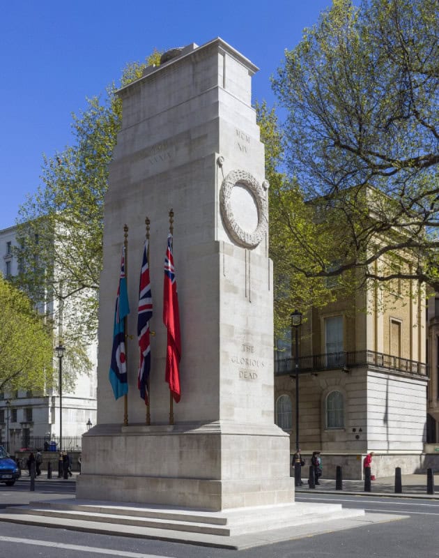 The Cenotaph in Whitehall, London, in Portland stone with flags on its sides